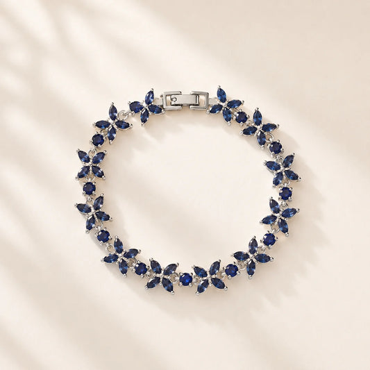 Blue floral gemstone bracelet arranged in a circular product view