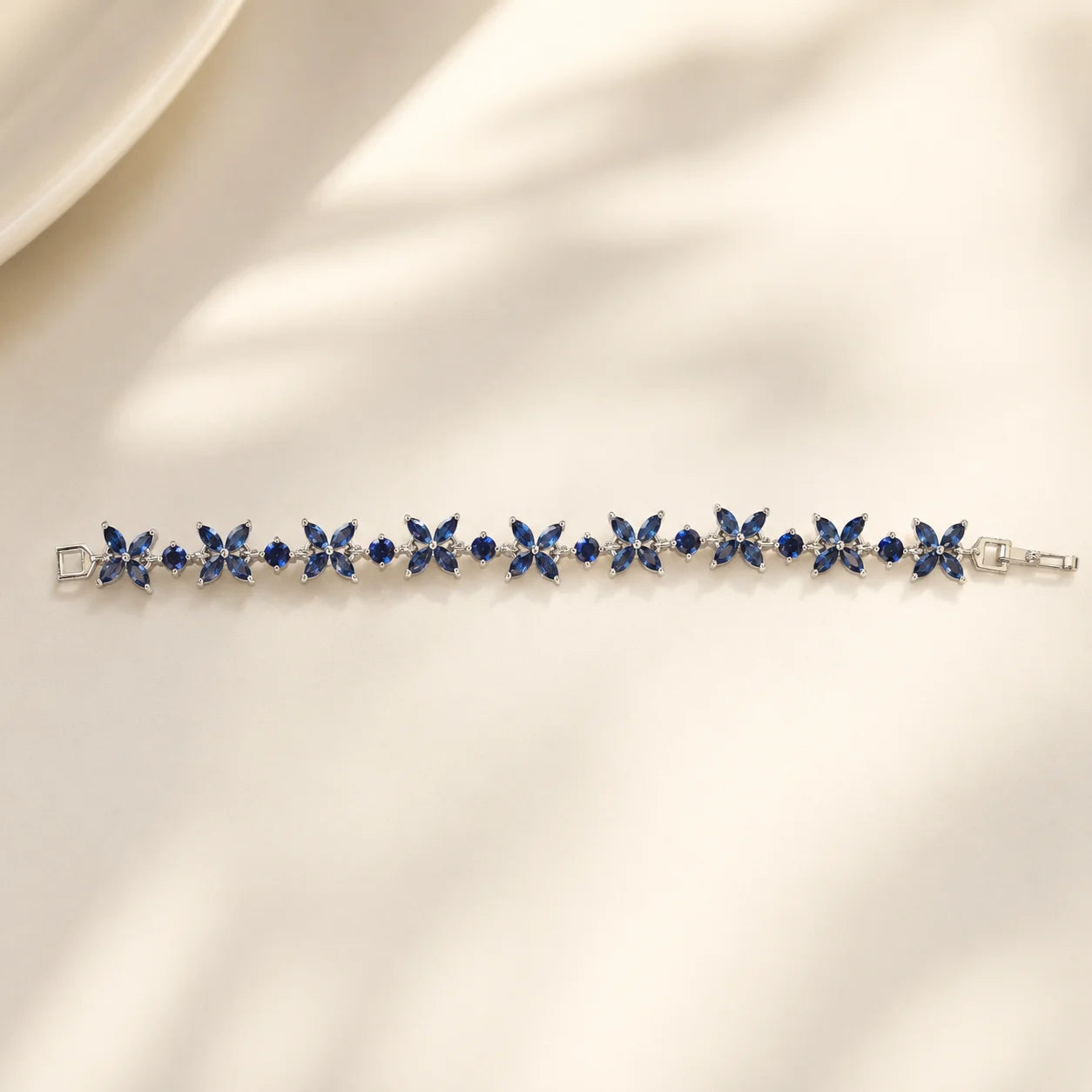 Blue floral gemstone bracelet shown flat in a full-length view