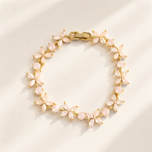 Pink floral gemstone bracelet arranged in a circular product view
