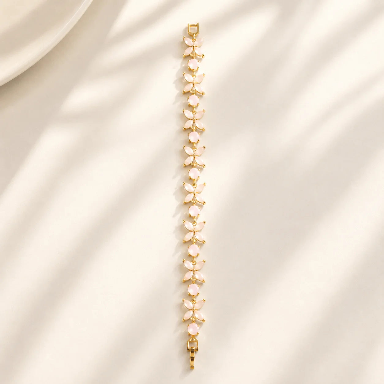 Pink floral gemstone bracelet shown flat in a full-length view