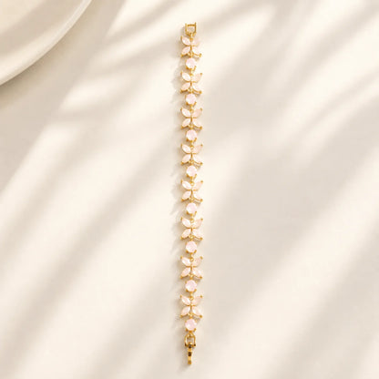 Pink floral gemstone bracelet shown flat in a full-length view