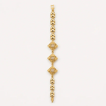 Gold bracelet with three geometric diamond-shaped centerpieces