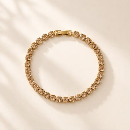 Gold crystal tennis bracelet arranged in a circular product view