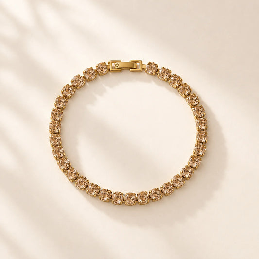 Gold crystal tennis bracelet arranged in a circular product view