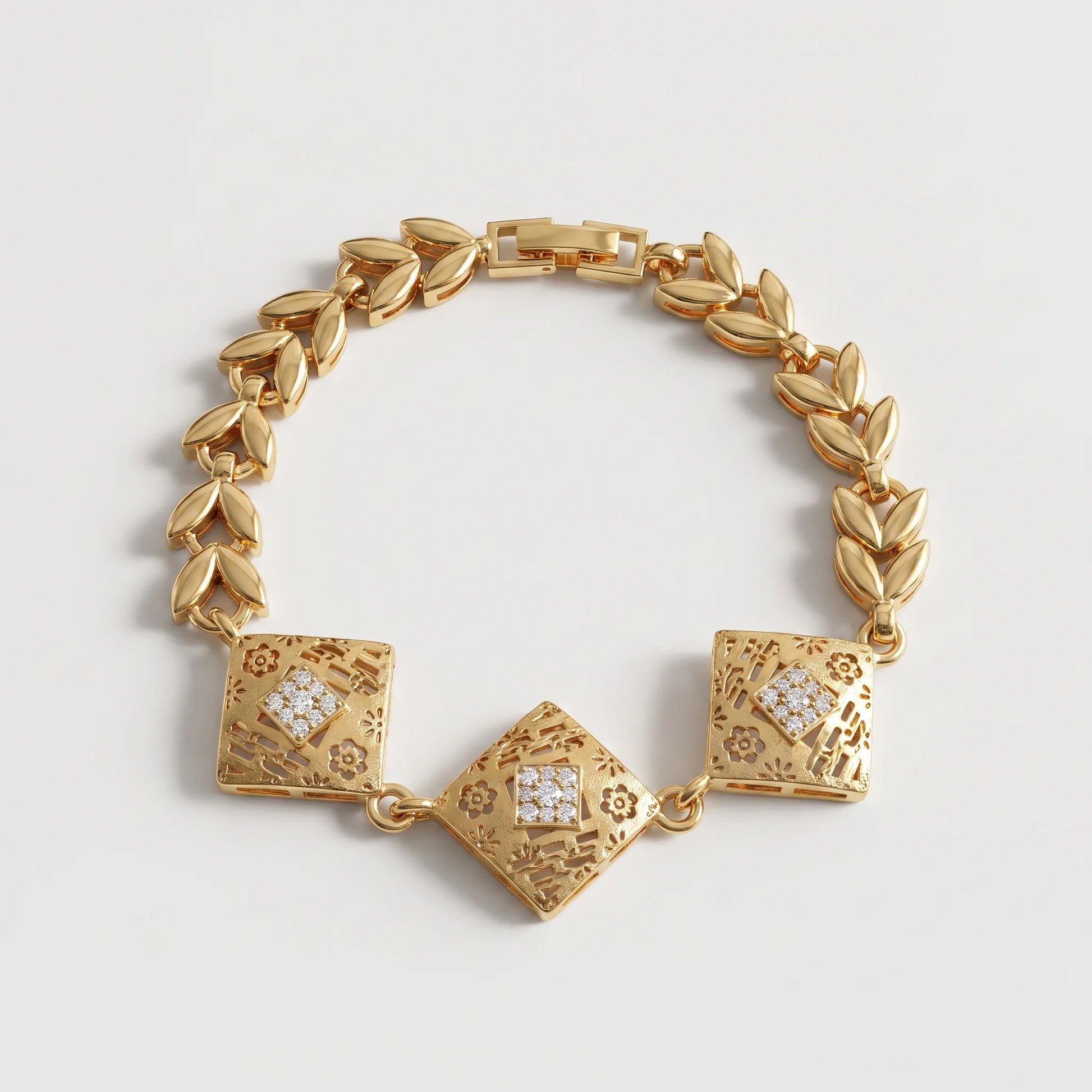 Chunky gold bracelet with three engraved geometric centerpieces