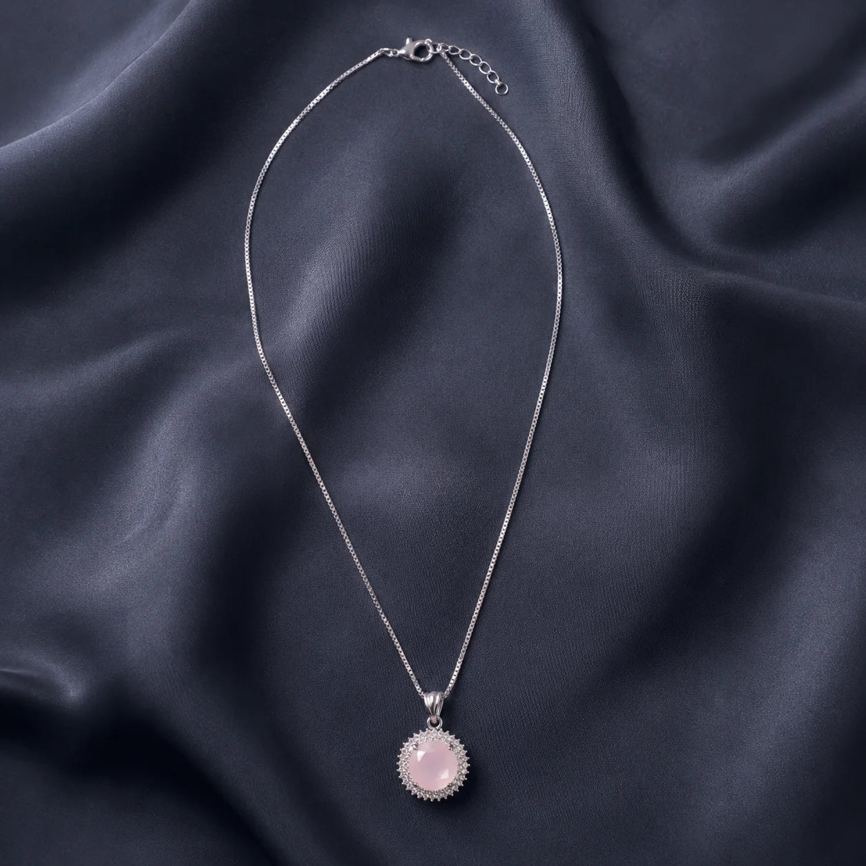 Silver necklace with round pink sunburst pendant full product view