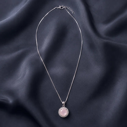 Silver necklace with round pink sunburst pendant full product view