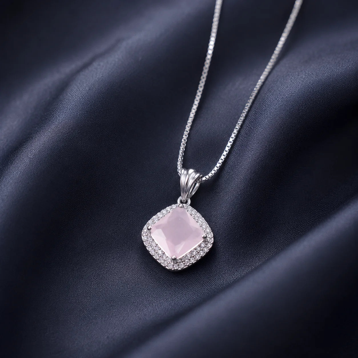 Silver necklace with pink square crystal pendant close-up
