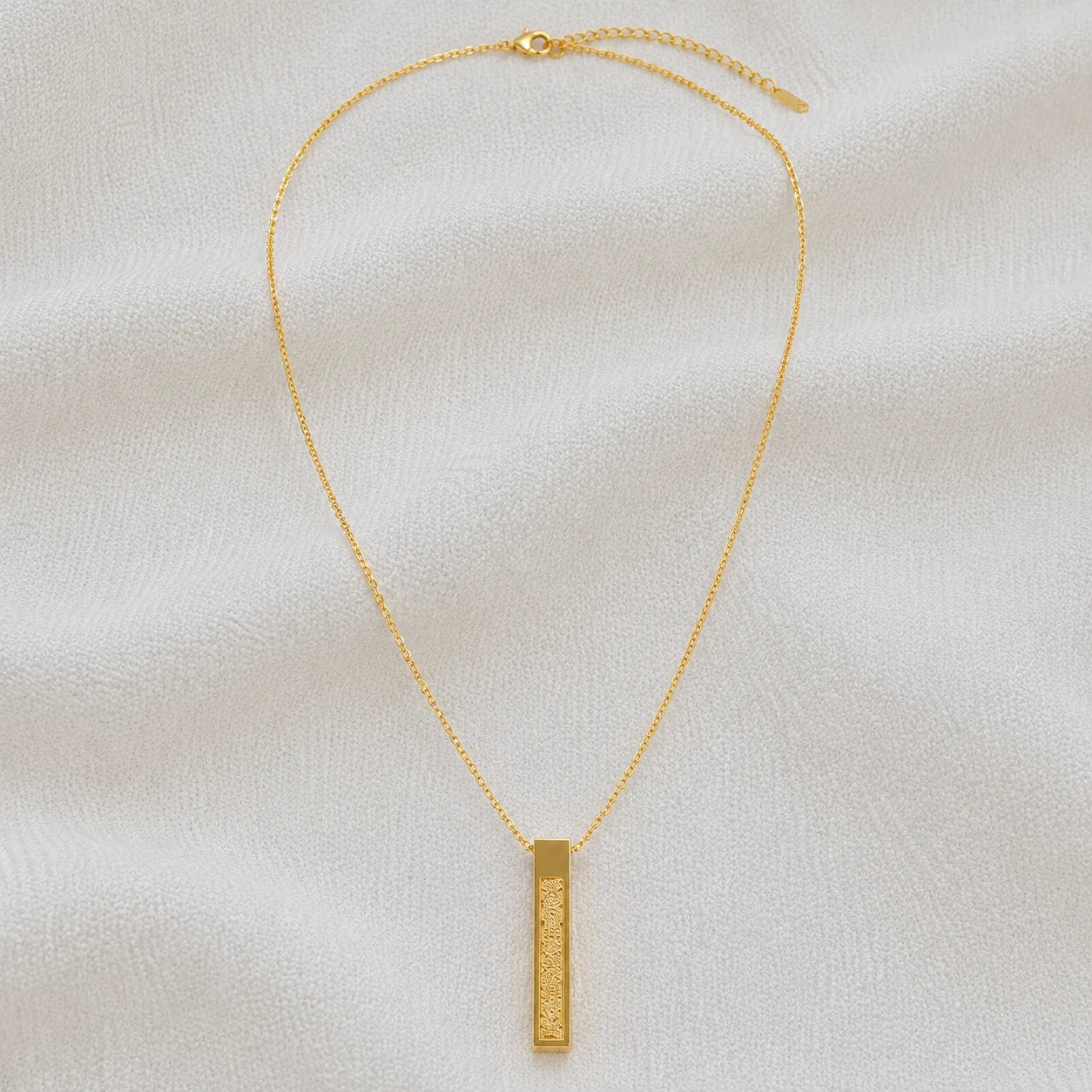 Gold necklace with engraved rectangular bar pendant full product view