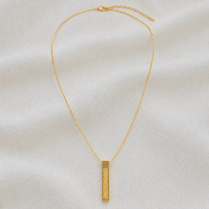 Gold necklace with engraved rectangular bar pendant full product view