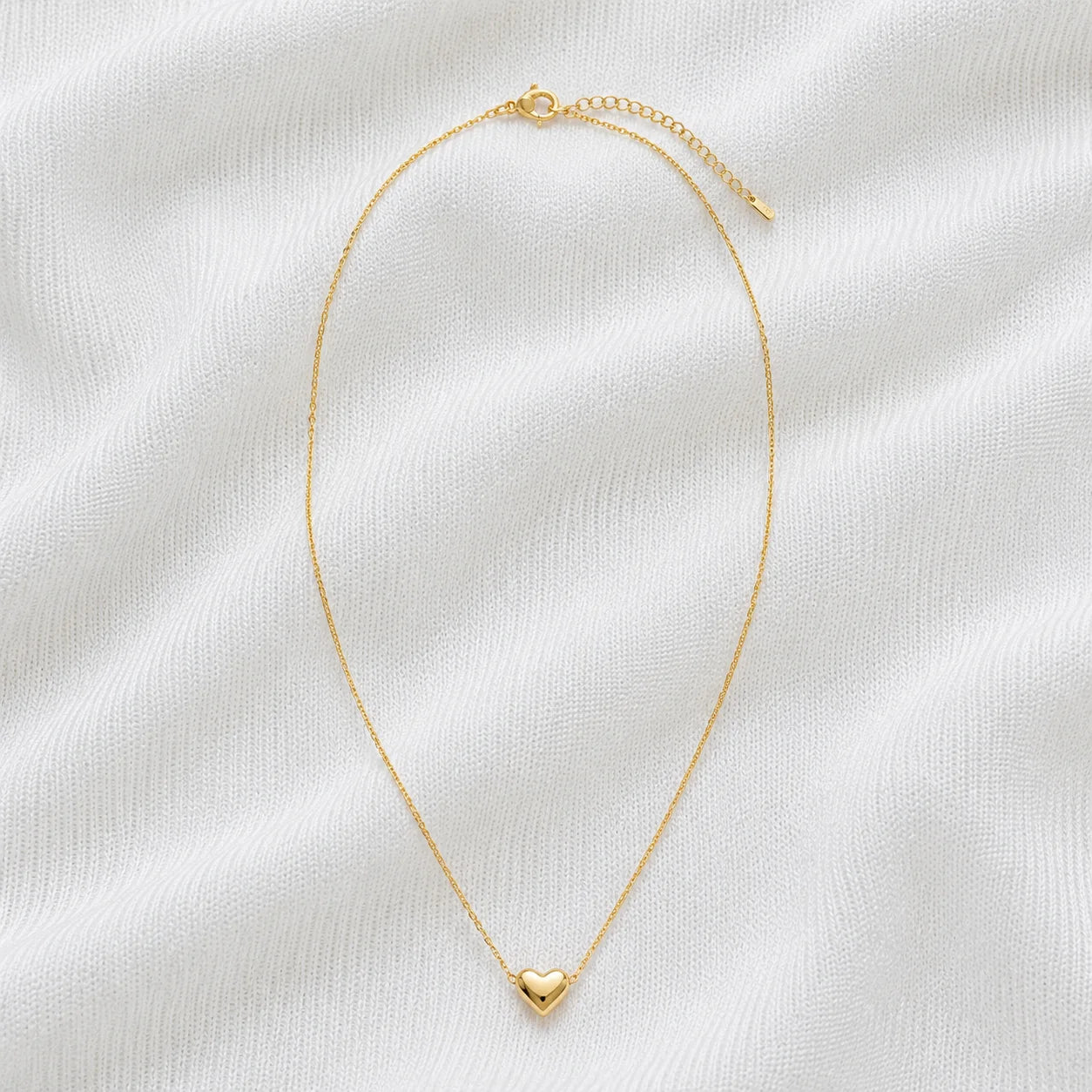 Delicate gold necklace with small heart pendant full product view