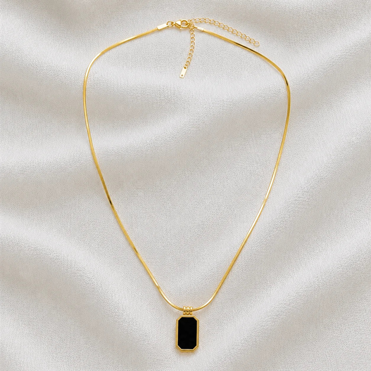 Gold snake-chain necklace with black rectangular pendant full product view