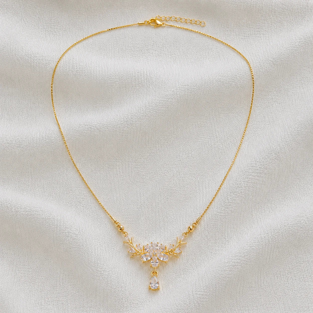 Delicate gold necklace with crystal floral pendant full product view