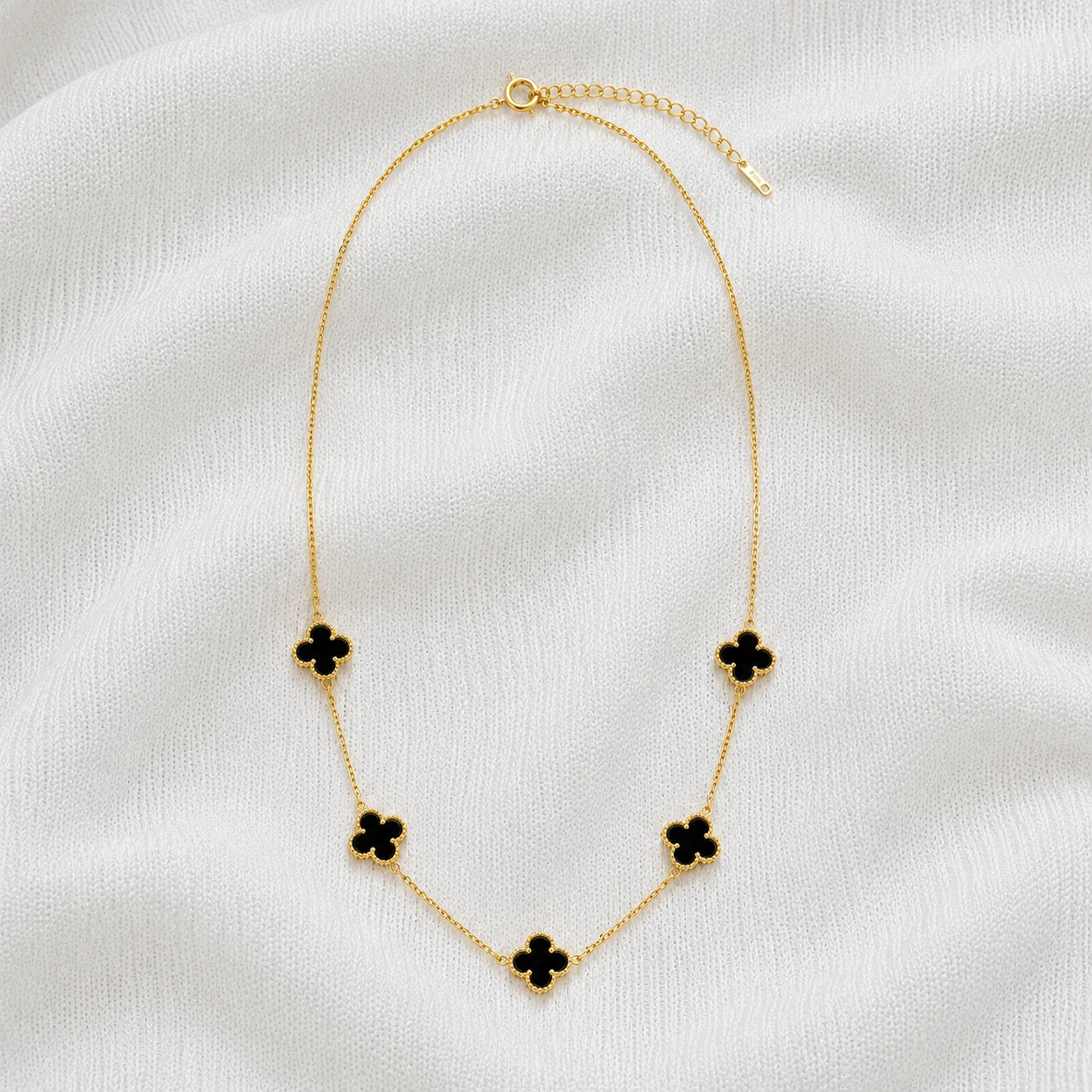 Gold necklace with five black clover stations full product view