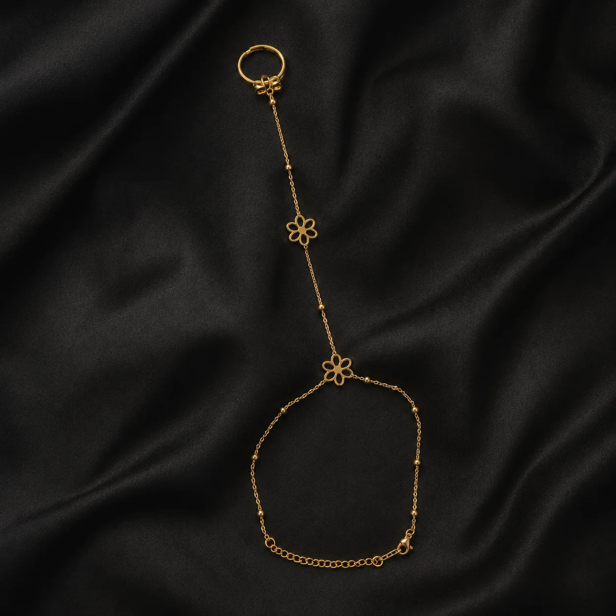 Gold three-flower hand chain shown flat in a full product view